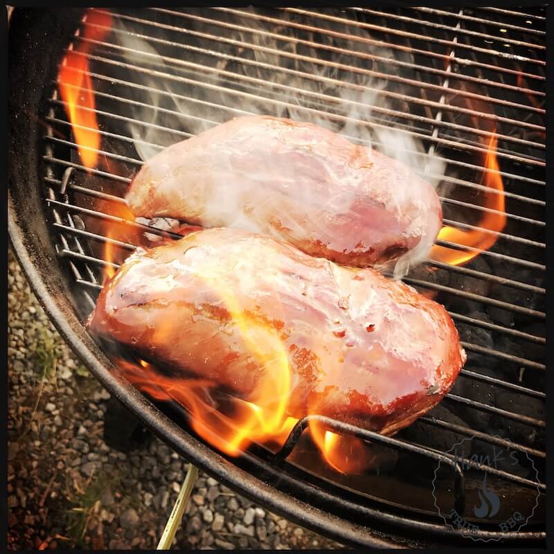 Duck breasts being seared over direct heat