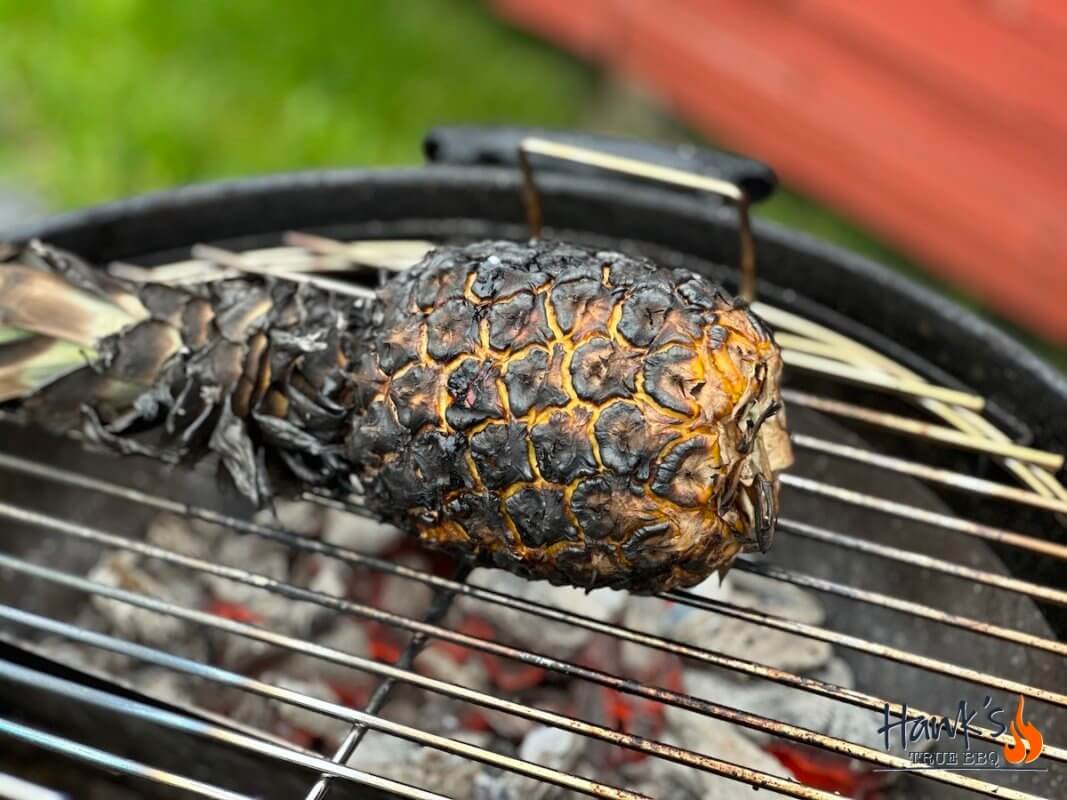 Grilling pineapple over glowing embers