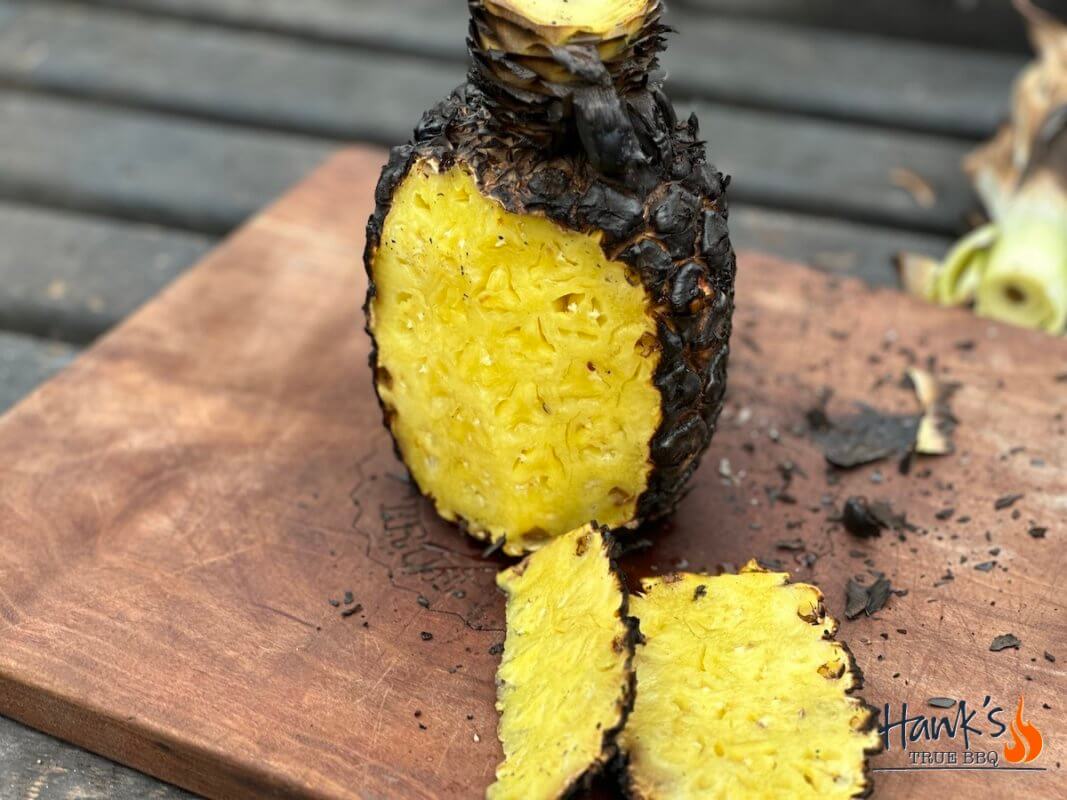 Grilled pineapple being sliced